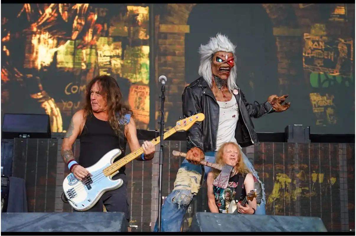 Escenario de Iron Maiden durante su actuación en el Rock Imperium Festival de Cartagena, con el bajista interpretando el concierto junto a la icónica mascota Eddie y un guitarrista al fondo bajo una espectacular iluminación.